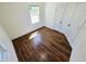 Bedroom featuring hardwood floors, white walls, baseboards, and a sunlit window at 710 Dothan Ave, Burlington, NC 27217