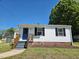 View of a one-story home showcasing clean white siding, black shutters, and a well-maintained lawn at 710 Dothan Ave, Burlington, NC 27217