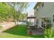 Backyard with patio, dining set, landscaping, and a retaining wall at 712 Wellspring Dr, Holly Springs, NC 27540