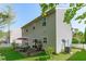 Exterior view of backyard with patio, dining set, plants, and vinyl siding at 712 Wellspring Dr, Holly Springs, NC 27540