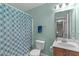 Cozy bathroom featuring light green walls, a combined tub and shower, and neutral accents at 712 Wellspring Dr, Holly Springs, NC 27540