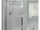 Bathroom featuring a sleek glass shower and a separate soaking tub by a frosted window at 712 Wellspring Dr, Holly Springs, NC 27540