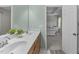 Bright bathroom with double sinks, wood cabinets, and ensuite access to the primary bedroom at 712 Wellspring Dr, Holly Springs, NC 27540