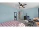 Well-lit bedroom featuring light blue walls, carpet, and a black dresser with mirror at 712 Wellspring Dr, Holly Springs, NC 27540