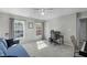 Versatile room with plush carpet, sofa, desk, and piano with natural light from two windows at 712 Wellspring Dr, Holly Springs, NC 27540