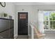 Bright foyer with sleek shoe cabinet, decorative mirror, and large window offering natural light at 712 Wellspring Dr, Holly Springs, NC 27540