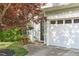Inviting front entrance with a two-car garage and tastefully landscaped surroundings at 712 Wellspring Dr, Holly Springs, NC 27540