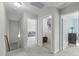 Hallway provides access to the laundry room, a living area, and another room with neutral paint and carpet at 712 Wellspring Dr, Holly Springs, NC 27540