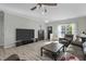 Modern living room featuring hardwood floors, neutral walls, and contemporary furnishings at 712 Wellspring Dr, Holly Springs, NC 27540