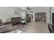 Open-concept living room featuring hardwood floors, comfortable seating, and stylish decor at 712 Wellspring Dr, Holly Springs, NC 27540