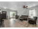 Bright and airy living room with hardwood floors, modern furnishings, and ample natural light at 712 Wellspring Dr, Holly Springs, NC 27540