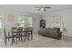 Open concept living room and dining area featuring hardwood floors and a cozy fireplace at 712 Wellspring Dr, Holly Springs, NC 27540