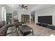 Spacious living room with hardwood floors, a ceiling fan, and a view to the dining area at 712 Wellspring Dr, Holly Springs, NC 27540