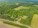 Aerial view of the property and surrounding wooded area with multiple dwellings at 7129 Dexter Rd, Oxford, NC 27565