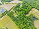 An aerial view shows various homes in a rural wooded and cultivated area at 7129 Dexter Rd, Oxford, NC 27565