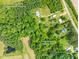 Aerial view of property showing approximate property lines, house, Dexter Road and surrounding lush greenery at 7129 Dexter Rd, Oxford, NC 27565