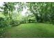 Expansive grassy backyard, shaded by mature trees, offering a serene and private outdoor space at 7129 Dexter Rd, Oxford, NC 27565