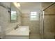 Bright bathroom featuring a neutral palette, tiled walls, and a shower with glass door at 7129 Dexter Rd, Oxford, NC 27565