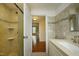 Bathroom featuring tiled walls, glass door shower, and entrance to a separate room at 7129 Dexter Rd, Oxford, NC 27565