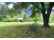 Outdoor setting with a metal bench, trees, and a small outbuilding offering a serene, peaceful atmosphere at 7129 Dexter Rd, Oxford, NC 27565