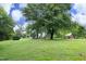Expansive property with a house, outbuilding, and green lawn, offering space and a countryside feel at 7129 Dexter Rd, Oxford, NC 27565