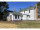 A full back exterior shot of a white multi-story home with a green roof, and a brick chimney at 7129 Dexter Rd, Oxford, NC 27565