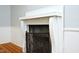 Bright room featuring a white fireplace with a metal screen and wood floors at 7129 Dexter Rd, Oxford, NC 27565