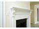 White mantel on a black fireplace with ceramic tile floor at 7129 Dexter Rd, Oxford, NC 27565