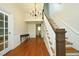 Open foyer featuring hardwood floors, staircase, wainscotting, and decorative chandelier at 7129 Dexter Rd, Oxford, NC 27565