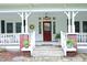 Charming two-story farmhouse with a welcoming front porch and inviting red front door at 7129 Dexter Rd, Oxford, NC 27565