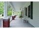 Inviting front porch with brick columns and a cozy seating area, ideal for relaxing outdoors at 7129 Dexter Rd, Oxford, NC 27565