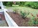 Charming front yard garden with blooming rose bushes, enhancing the curb appeal of the property at 7129 Dexter Rd, Oxford, NC 27565