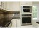 KitchenAid stainless steel wall oven and microwave with gray backsplash at 7129 Dexter Rd, Oxford, NC 27565