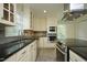 Bright kitchen features white cabinets, granite countertops and stainless steel appliances at 7129 Dexter Rd, Oxford, NC 27565