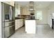 Bright kitchen features white cabinets, granite countertops and stainless steel appliances and refrigerator at 7129 Dexter Rd, Oxford, NC 27565