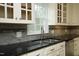 Close-up of the kitchen sink with stainless steel faucet and gray backsplash at 7129 Dexter Rd, Oxford, NC 27565