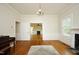 Living room featuring hardwood floors, wainscoting, fireplace, and open doorway at 7129 Dexter Rd, Oxford, NC 27565