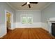 Neutral-toned living room with hardwood floor, fireplace and access to porch at 7129 Dexter Rd, Oxford, NC 27565