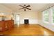 Living room boasting hardwood floors, wainscoting, decorative ceiling fan, and abundant natural light at 7129 Dexter Rd, Oxford, NC 27565