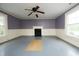 Spacious living room with wood floors, large windows, and a white fireplace at 7129 Dexter Rd, Oxford, NC 27565