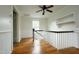 View of a bright loft area with wood floors, a window, and a ceiling fan at 7129 Dexter Rd, Oxford, NC 27565