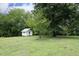 Charming outbuilding with white siding, perfect for a workshop or additional storage space on the property at 7129 Dexter Rd, Oxford, NC 27565
