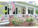 Charming two-story farmhouse with a welcoming porch and beautiful roses at 7129 Dexter Rd, Oxford, NC 27565