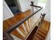 View of the wood staircase with white railings and a dark wood banister at 7129 Dexter Rd, Oxford, NC 27565