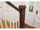 Stairway with wood steps, white railings, and a dark wood banister at 7129 Dexter Rd, Oxford, NC 27565