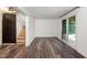 An unfinished basement has vinyl floors, stairs, and a sliding glass door at 7324 Summerland Dr, Raleigh, NC 27612