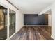 Spacious basement with vinyl floors, black accent wall, and walkout access to the yard at 7324 Summerland Dr, Raleigh, NC 27612