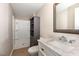 Neutral toned bathroom with a built-in shower and cabinet for storage at 7324 Summerland Dr, Raleigh, NC 27612