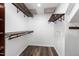 A storage area with multiple shelves and a small door at 7324 Summerland Dr, Raleigh, NC 27612