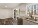 Kitchen with stainless steel sink, granite countertops, and sliding glass door to deck at 7324 Summerland Dr, Raleigh, NC 27612